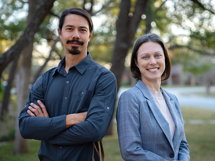 Adam Eurich and Cassandra Gearhart Ph.D. standing side by side, smiling and looking relaxed and happy at the camera