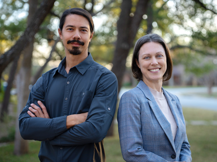 Cassandra-&-Adam-Standing Adam Eurich and Cassandra Gearhart Ph.D. standing side by side, smiling and looking relaxed and happy at the camera